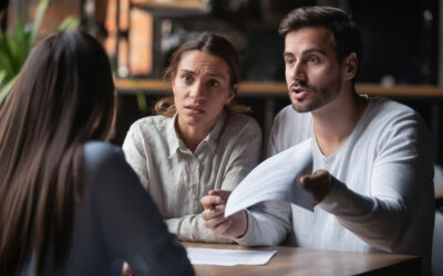 lawyer-dropped-my-car-accident-case-texas Frustrated couple reviewing legal paperwork after lawyer dropped their car accident case in Texas